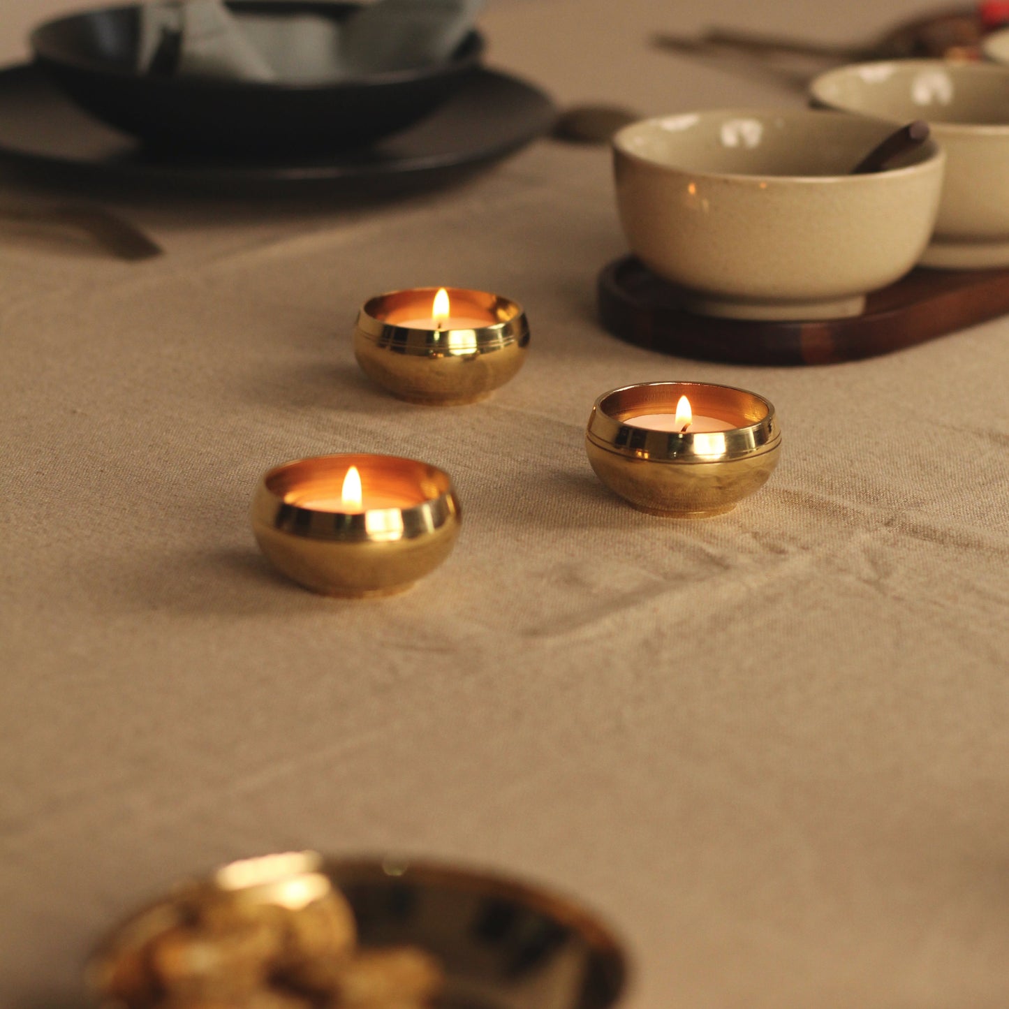 Brass tealight holders placed in a table setting