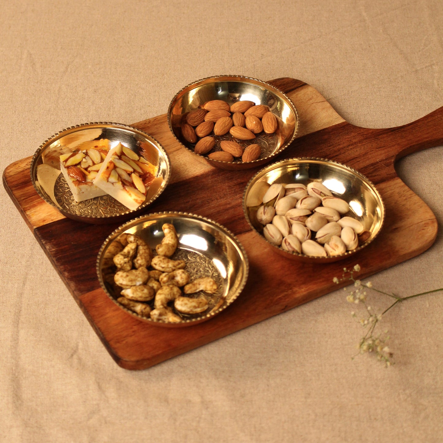 4 brass plates set on a platter