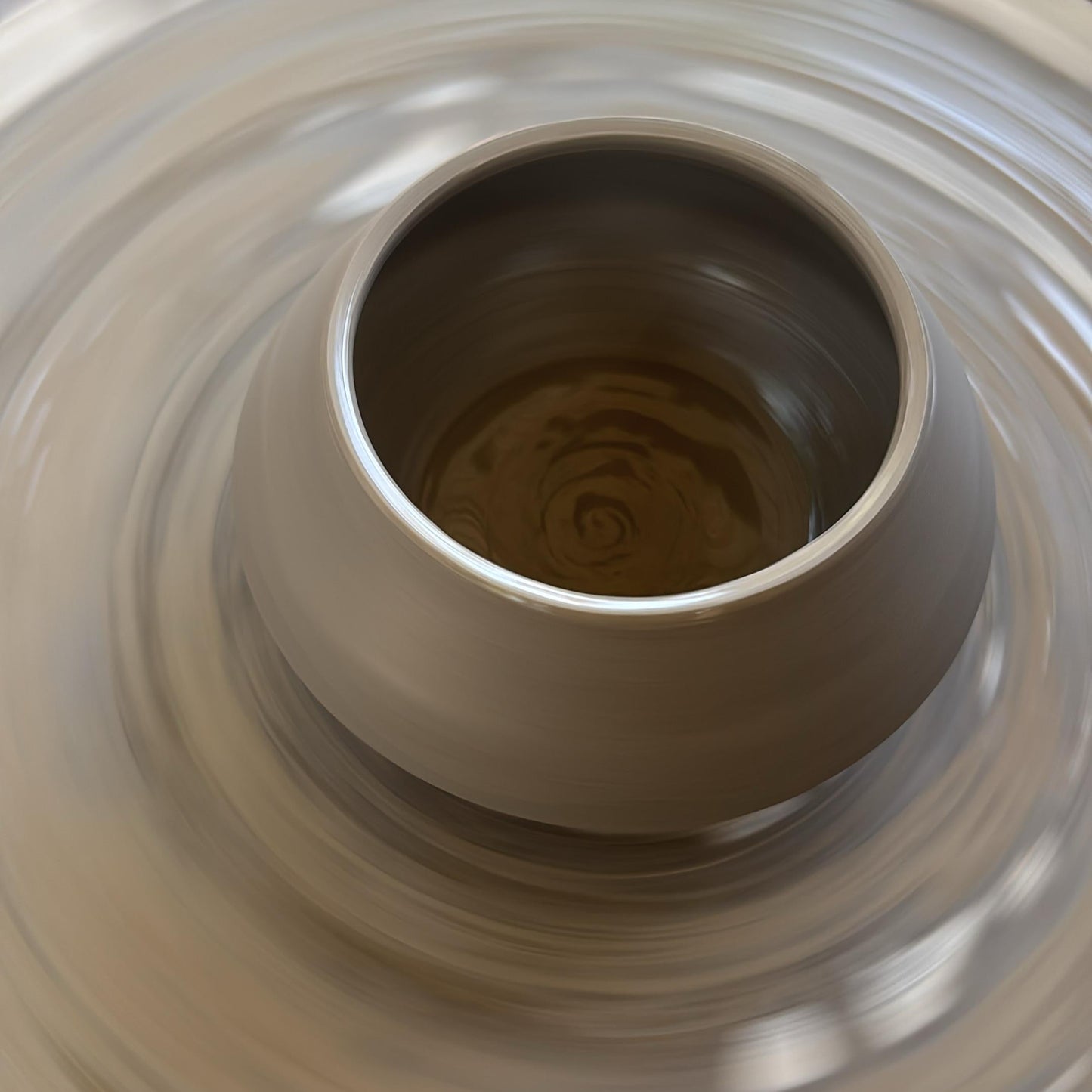 Close-up of a ceramic tealight holder being wheel thrown