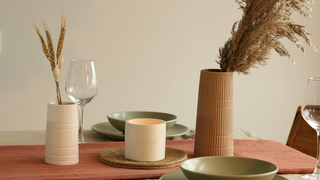 An aesthetic dining table setup with nivarah's vase and candle