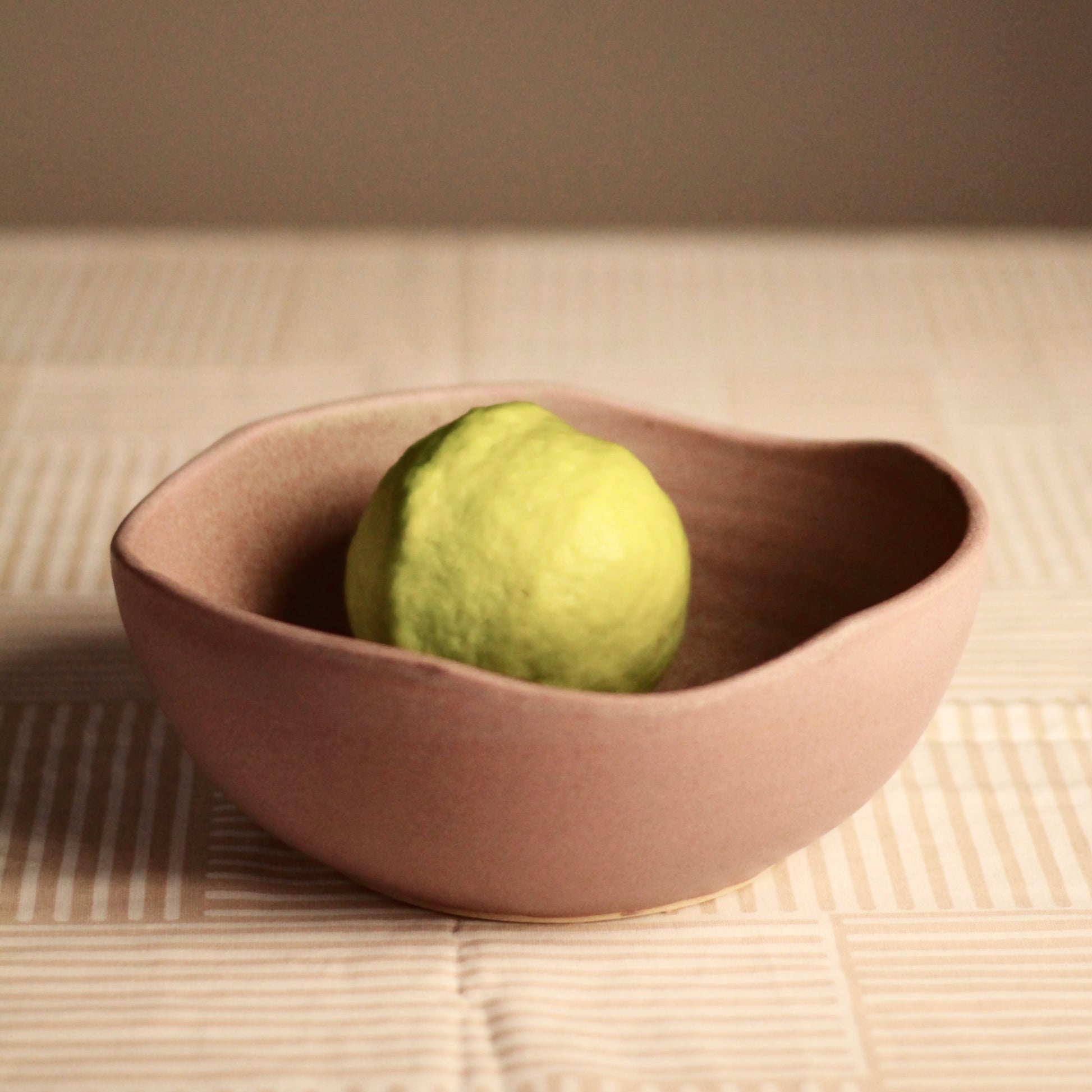 Ceramic decor bowl with a fruit on a table