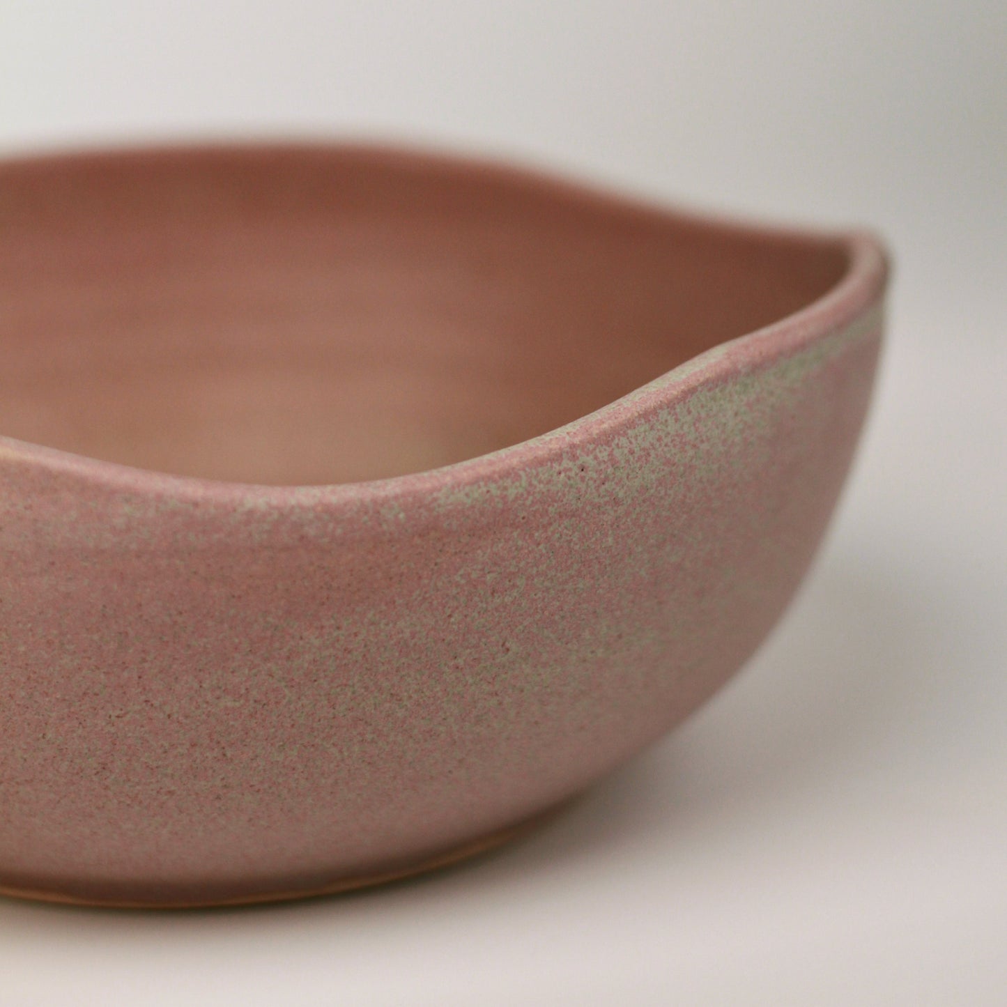 Pink-muave ceramic bowl on a neutral background showing 