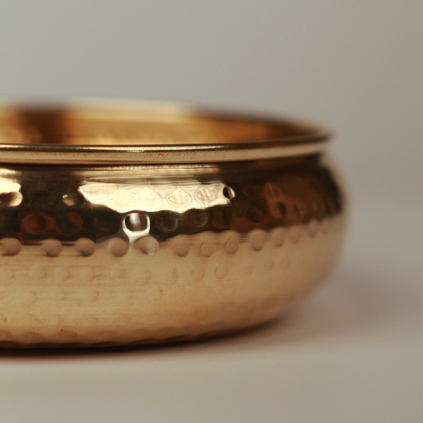 Details of hammered outer surface of taksh brass bowl