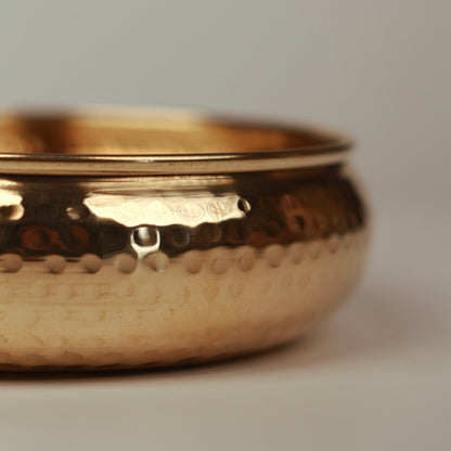 Details of hammered outer surface of taksh brass bowl