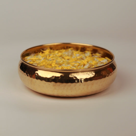 Taksh brass bowl placed on a neutral background