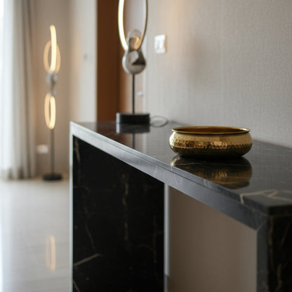 Modern interior with a black marble console table and taksh decor bowl.